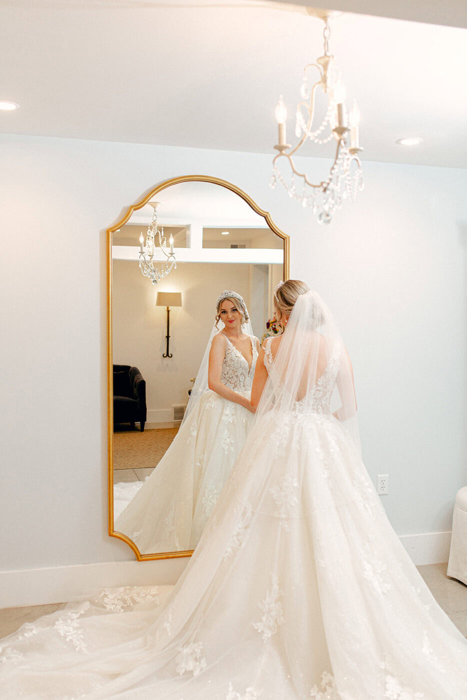 Wedding dress reflection in mirror, bride preparing at Verterra Winery for wedding.